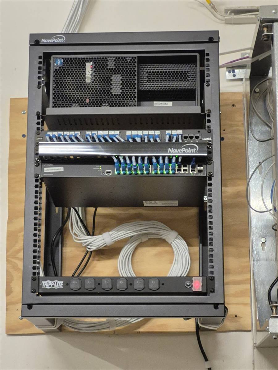 Office network rack buildout — patch panel, switch and PDU in a wall-mounted enclosure